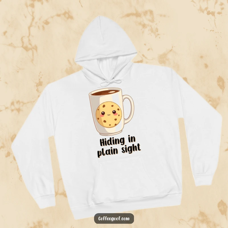 Funny hoodie with a shy cookie peeking from behind a giant coffee mug, offering warmth and adorable, baked-good sweetness.