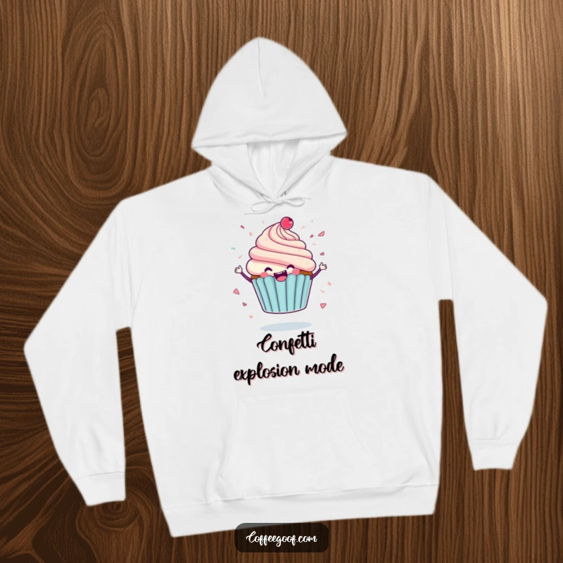Funny hoodie featuring a delighted cupcake character mid-spin, icing flying like confetti, offering warmth and a joyful, humorous expression.