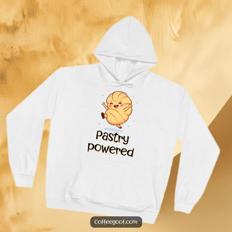 Funny croissant hoodie showing a grinning pastry doing a lively cartwheel, decorated with colorful sprinkles, full of energy.