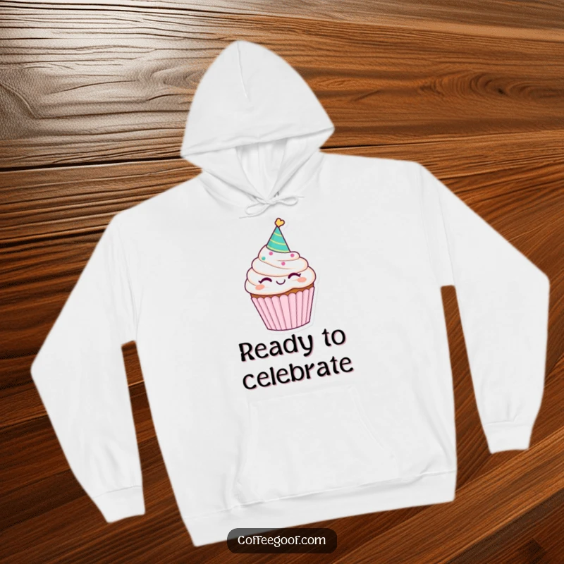 Funny winking cupcake hoodie, sporting a party hat, offering a cozy and humorous design that’s perfect for celebrations.