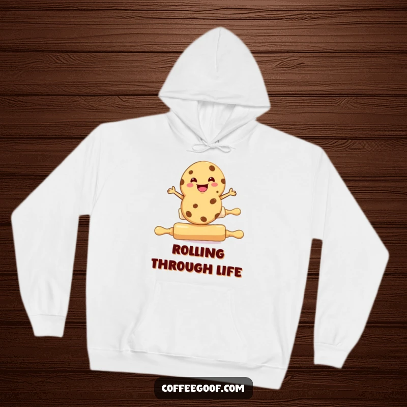 Funny cookie hoodie, a grinning cookie balancing on a rolling pin, cozy baking apparel.