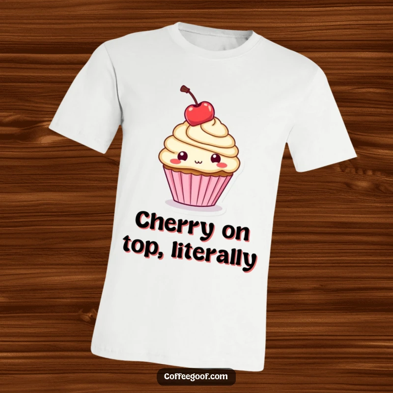 Funny T-Shirt: A cute cupcake character is shown balancing a cherry on its head with playful, sugary charm.