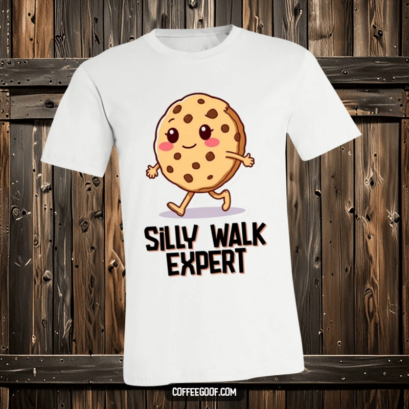 Funny T-Shirt: A sentient cookie character hilariously attempts a silly walk, crumbling slightly mid-step, embodying playful clumsiness.