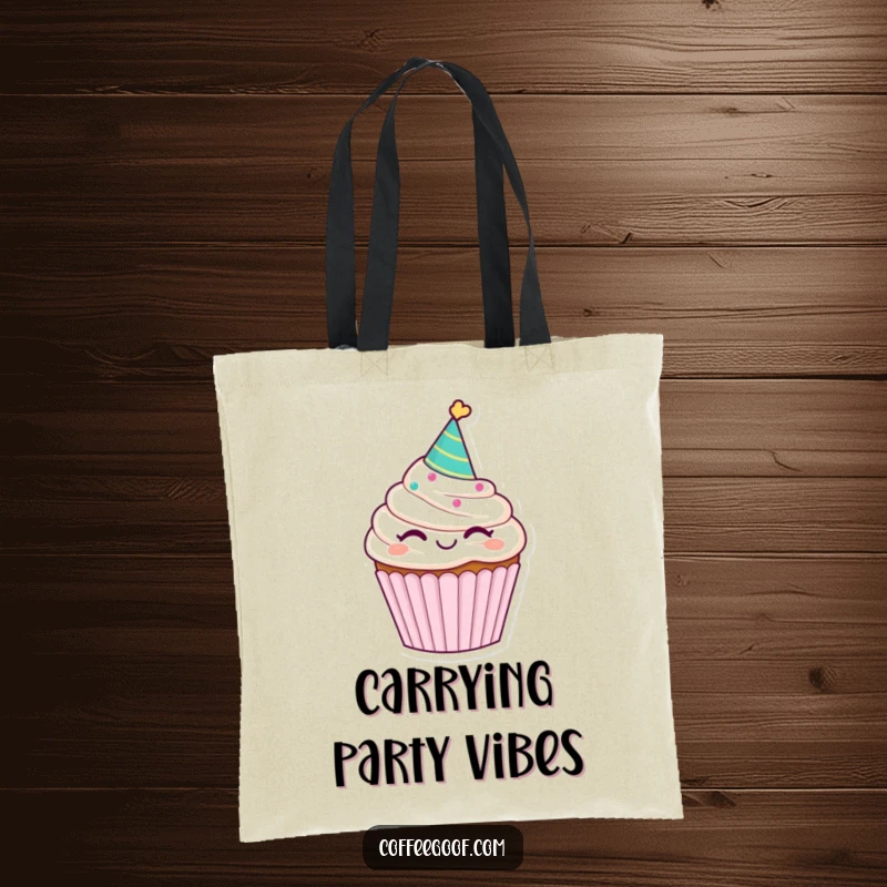 Funny winking cupcake tote bag, wearing a party hat, ideal for carrying essentials with a dash of sweet humor.